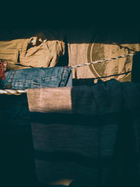 Close-up of open book on bed against wall