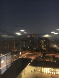 High angle view of illuminated buildings in city at night