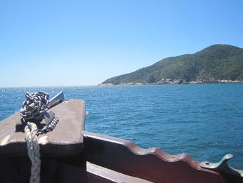 Close-up of sea against clear blue sky