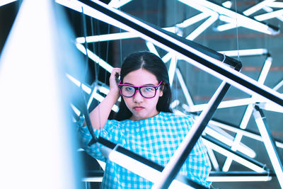 Portrait of woman amidst illuminated lights