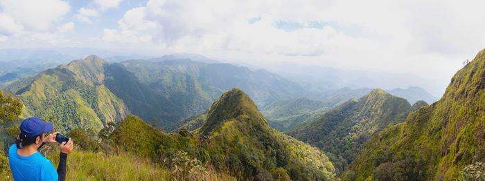 Panoramic shot of man photographing on mountain
