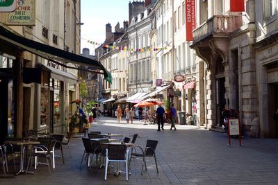 People on street amidst buildings in city