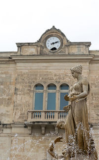 Low angle view of fountain against building