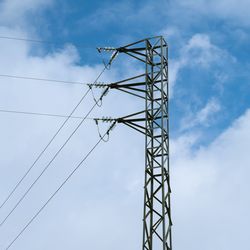 Low angle view of electricity pylon against sky