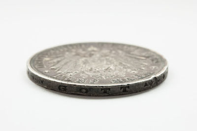 High angle view of coins on white background