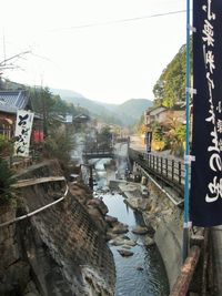 Boats in river with buildings in background