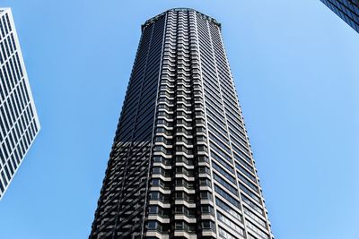 Low angle view of modern building against blue sky