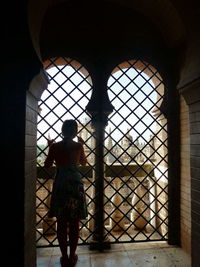 Woman looking through window