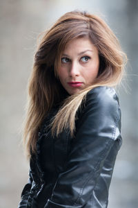 Young woman with brown hair looking away