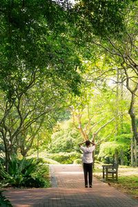 Rear view of woman walking on footpath