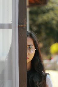 Portrait of woman in glass window