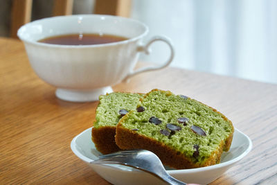 Close-up of cake and tea cup served on table