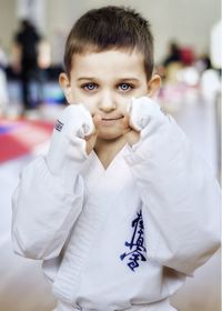 Portrait of cute boy wearing martial arts uniform