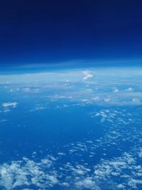 Aerial view of sea against blue sky