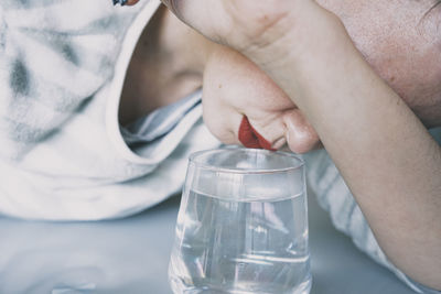 Close-up of boy drinking water in glass