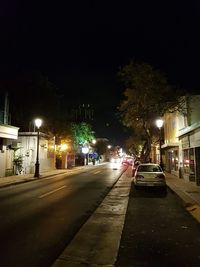 Illuminated city street at night