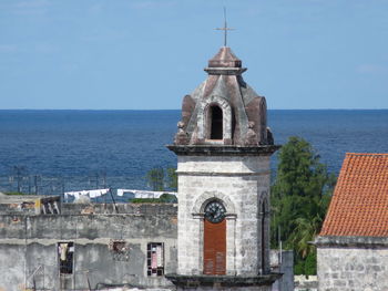 Church by sea against clear sky