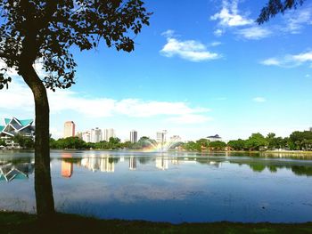 Calm lake with buildings in background