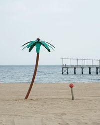 Umbrella on beach against clear sky