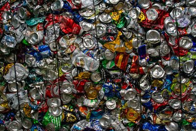Crushed aluminium cans in recycling bales textured environmental background 