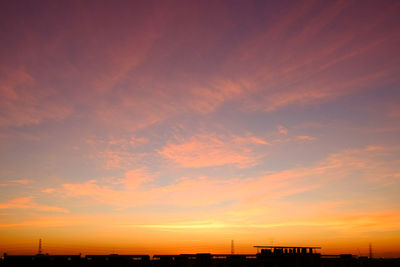 Silhouette buildings against sky during sunset