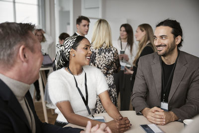 Smiling people talking during coffee break