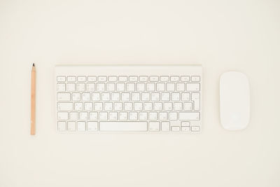Directly above shot of computer keyboard against white background