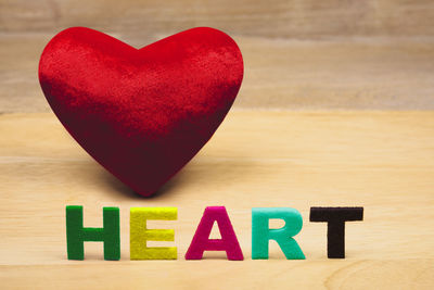 Close-up of heart shape decoration with text on table