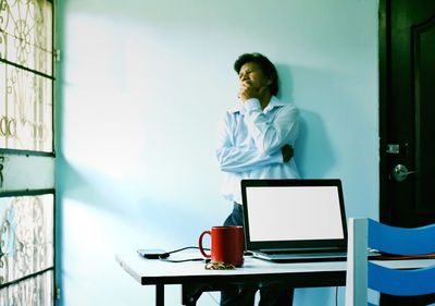 Man working on table at home