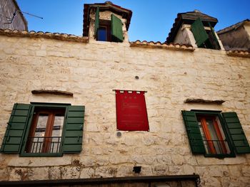 Low angle view of old house against sky