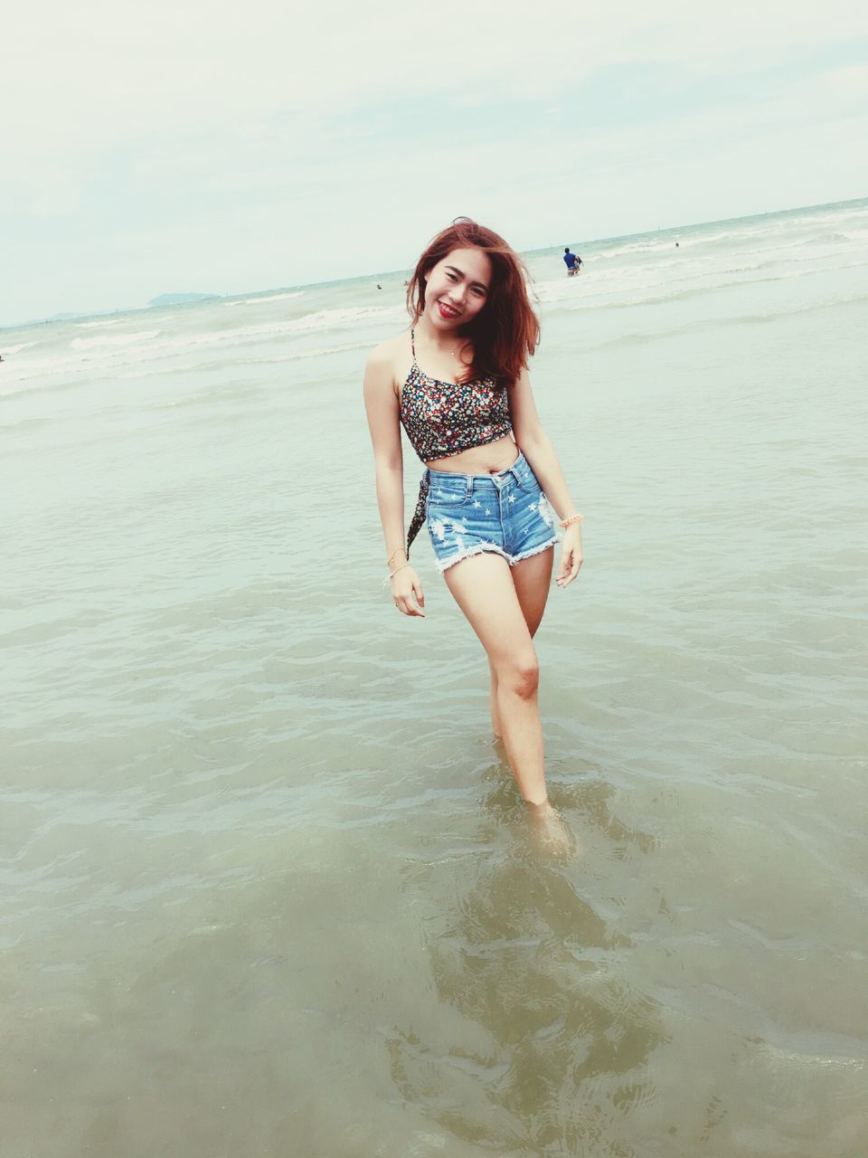 water, sea, beach, person, young adult, shore, lifestyles, portrait, leisure activity, full length, young women, looking at camera, sand, vacations, casual clothing, horizon over water, front view, sky