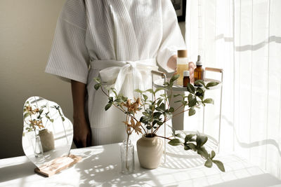 Midsection of woman with bouquet