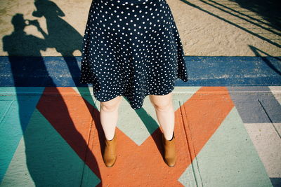 Low section of woman standing on tiled floor
