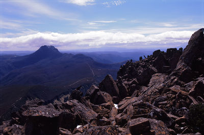 Scenic view of mountains against cloudy sky