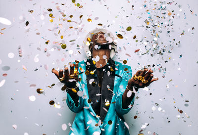 Portrait of happy man standing against multi colored background