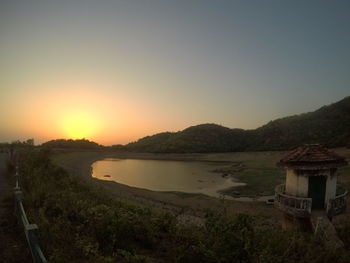 Scenic view of landscape against clear sky during sunset