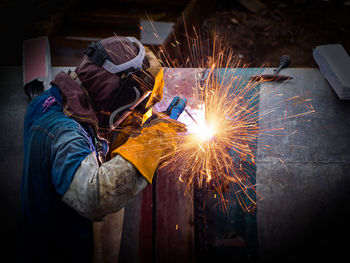 Man working on metal in factory