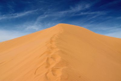 Low angle view of sand dune at sahara desert against sky