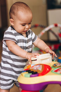 Cute boy playing with baby girl