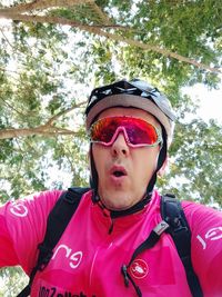 Portrait of man wearing sunglasses against trees