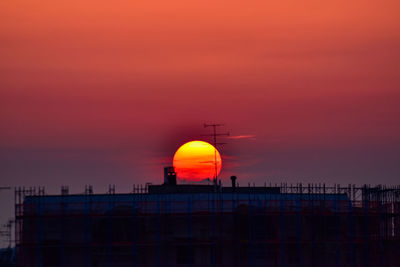 Built structure against orange sky during sunset