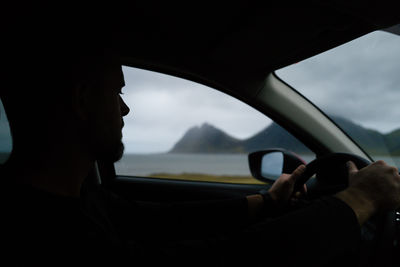 Low section of man driving car