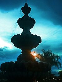 Low angle view of silhouette statue against sky