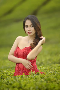 Beautiful young woman standing on field