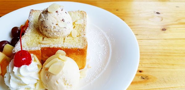 Close-up of cake and icecream in plate on table