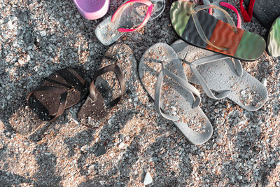 High angle view of flip flops  on beach sand 