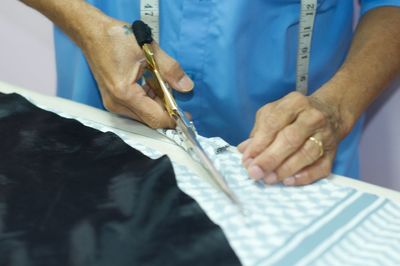 Midsection of man working in pen