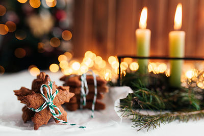 Christmas decorations with candles, fir branches and gingerbread. high quality photo