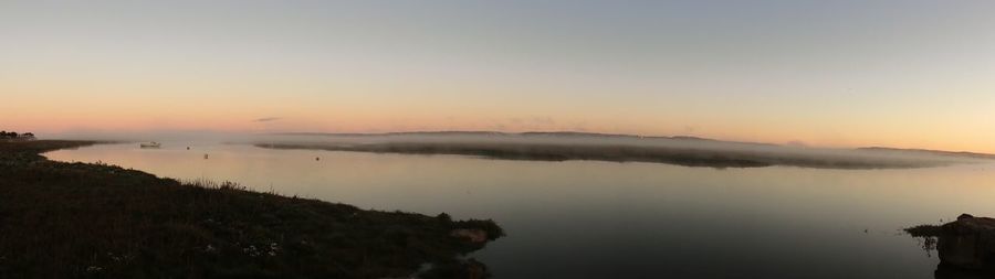 Panoramic view of sea against sky during sunset