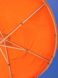 Low angle view of orange umbrella